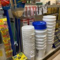 image of store display shelves carrying empty paint buckets, brooms and shop towels
